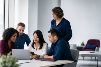 Happy Small Business Employees Reviewing Benefits in Office